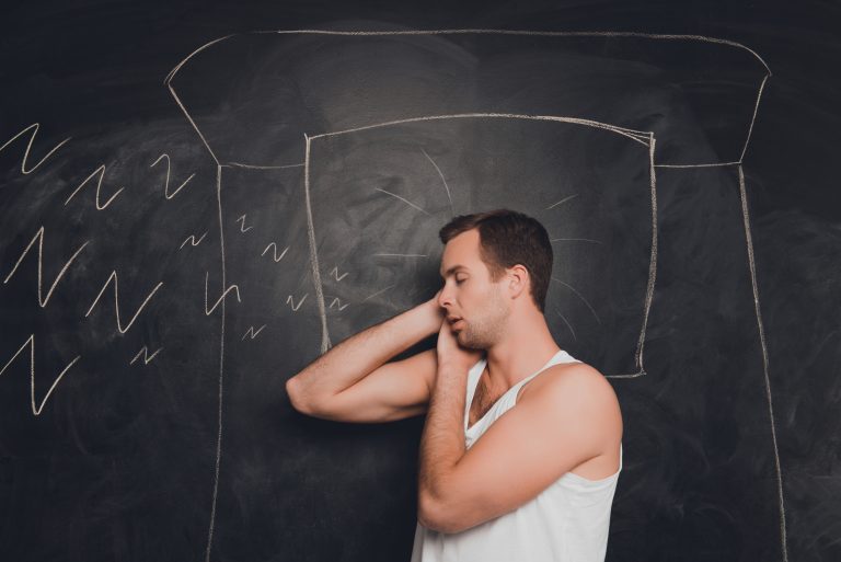Young man against the background of chalkboard sleeping and snor