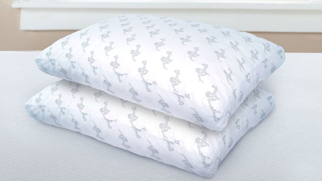 Two MyPillow Premium pillows stacked on a mattress by a window