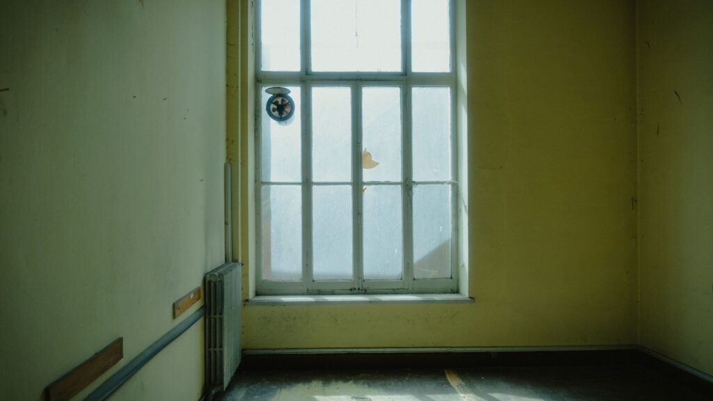 Sunlight from a window across the floor of a bare room